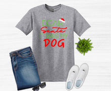 Load image into Gallery viewer, Gray t-shirt with 'Dear Santa, It Was My Dog' text, paired with jeans, sunglasses, and white sneakers on a white background.