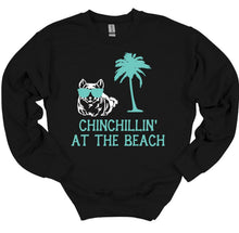 Load image into Gallery viewer, Black sweatshirt with a graphic of a chinchilla, palm tree, and text 'Chinchillin' at the Beach' on a white background.