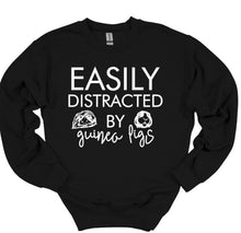 Load image into Gallery viewer, Black sweatshirt with white text 'EASILY DISTRACTED BY guinea pigs' on a white background