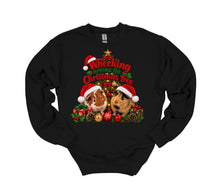 Load image into Gallery viewer, A black long-sleeve crewneck sweatshirt featuring a festive Christmas graphic of two guinea pigs wearing Santa hats, surrounded by ornaments, pinecones, and the text 'Wheeking Around the Christmas Tree'.