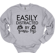 Load image into Gallery viewer, Gray sweatshirt with black text 'EASILY DISTRACTED BY guinea pigs' on a white background