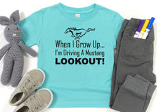 Load image into Gallery viewer, Light blue t-shirt with Mustang graphic and text, paired with gray shoes, pants, and a stuffed animal on a white background.
