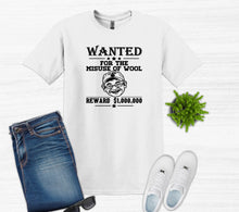 Load image into Gallery viewer, A white graphic t-shirt featuring a black 'WANTED' poster design for 'The Misuse of Wool'. The shirt is styled in a flat-lay arrangement with blue jeans, white sneakers, sunglasses, and a small green plant on a white wood-textured background.