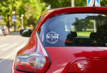 Load image into Gallery viewer, Red car with a white not perfect just forgiven with cross decal on the back window, parked outdoors with trees and a road in the background.