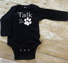 Load image into Gallery viewer, Black baby onesie with 'Talk to the paw' text on a wooden surface