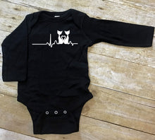 Load image into Gallery viewer, Black baby bodysuit with a cat heart design on a wooden surface