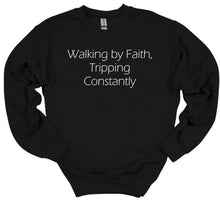 Load image into Gallery viewer, Black sweatshirt with white text 'Walking by Faith, Tripping Constantly' on a white background