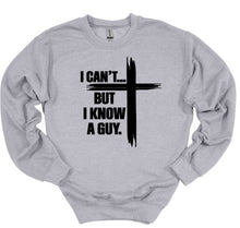 Load image into Gallery viewer, Gray sweatshirt with black I can't but I know a guy text and cross design on a white background