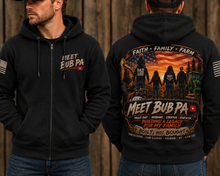 Load image into Gallery viewer, A man modeling a black zip-up hoodie, showing both the front and back views. The front features a small 'MEET BUB PA' logo on the left chest, and the back has a large, detailed graphic with the same text, featuring silhouettes of a family, an American flag, and a tractor on a rustic wooden background.